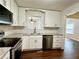Kitchen view with white cabinets, subway tile backsplash, stainless steel appliances, and granite countertops at 485 Angham Rd, Hiram, GA 30141