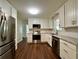 Modern kitchen featuring stainless steel appliances, white cabinets, granite countertops, and wood flooring at 485 Angham Rd, Hiram, GA 30141