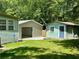 Diverse outbuildings including a shed and garage, offering ample storage and workspace on this property at 485 Angham Rd, Hiram, GA 30141