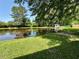 Expansive pond and lush green space with a wooden dock create a serene backyard oasis at 485 Angham Rd, Hiram, GA 30141