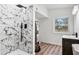 Modern bathroom featuring a walk-in shower with stylish marble tile and updated fixtures at 5153 Westbrook Pl, Union City, GA 30291