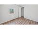 Bright bedroom with wood-look floors, a window view, and neutral paint at 5153 Westbrook Pl, Union City, GA 30291