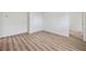 Bright bedroom with wood-look floors, neutral paint, and closet access at 5153 Westbrook Pl, Union City, GA 30291