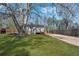 Home exterior featuring a large yard, mature trees, and a ramp at 5153 Westbrook Pl, Union City, GA 30291