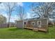 Back exterior of home showcasing deck and a well-manicured lawn at 5153 Westbrook Pl, Union City, GA 30291