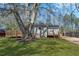 Charming home with a well-maintained lawn, mature trees, and a ramp entrance at 5153 Westbrook Pl, Union City, GA 30291