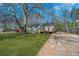 Home exterior showing a large yard and mature trees at 5153 Westbrook Pl, Union City, GA 30291
