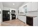 Bright kitchen featuring white cabinets, wood countertops, and modern appliances at 5153 Westbrook Pl, Union City, GA 30291