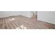 Well-lit room with wood-look flooring, neutral paint, and a modern aesthetic at 5153 Westbrook Pl, Union City, GA 30291