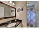 Elegant bathroom featuring granite countertops and a decorative shower curtain at 6700 Roswell Rd # 22B, Atlanta, GA 30328