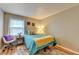 Bright bedroom featuring cheerful decor, a cozy bed, and hardwood floors at 6700 Roswell Rd # 22B, Atlanta, GA 30328