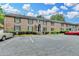 Exterior view of the townhouse complex featuring a parking lot in front of the building at 6700 Roswell Rd # 22B, Atlanta, GA 30328