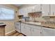 Bright kitchen showing white cabinets, granite countertops, modern appliances, and sink at 6700 Roswell Rd # 22B, Atlanta, GA 30328