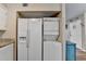 Kitchen features modern refrigerator, stacked washer/dryer, and clean design at 6700 Roswell Rd # 22B, Atlanta, GA 30328