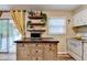 Bright kitchen boasts floating shelves, stainless microwave, and sliding door with outdoor view at 6700 Roswell Rd # 22B, Atlanta, GA 30328