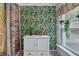 Bright sunroom featuring tropical wallpaper, a cabinet, and light-filled windows with potted plants at 6700 Roswell Rd # 22B, Atlanta, GA 30328