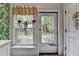 The sunroom features tropical wallpaper, and a door leading to the outdoors, with a view of trees at 6700 Roswell Rd # 22B, Atlanta, GA 30328
