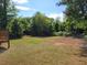 The property has a large private backyard surrounded by mature trees and natural foliage at 1094 Reynolds Ct, Morrow, GA 30260