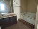 Bathroom with a jacuzzi tub, vanity with sink, and neutral-toned walls at 1094 Reynolds Ct, Morrow, GA 30260