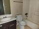 Bathroom featuring a toilet, sink with dark vanity, and shower/tub combo at 1094 Reynolds Ct, Morrow, GA 30260
