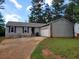 Cozy single-story home with a garage, stone accents, and a well-maintained lawn at 1094 Reynolds Ct, Morrow, GA 30260
