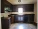 Functional kitchen with dark cabinetry, black appliances, and a window over the sink at 1094 Reynolds Ct, Morrow, GA 30260