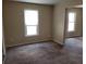 Inviting living room featuring carpeted floors and plenty of natural light from two windows at 1094 Reynolds Ct, Morrow, GA 30260