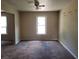 Bright living room with a ceiling fan and natural light streaming through the windows at 1094 Reynolds Ct, Morrow, GA 30260
