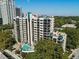 Stunning aerial view of a high-rise apartment building with a pool deck and lush green surroundings in a city setting at 1130 Piedmont Ne Ave # 709, Atlanta, GA 30309