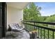 Relaxing balcony featuring a comfortable rocking chair and lovely green views at 1130 Piedmont Ne Ave # 709, Atlanta, GA 30309