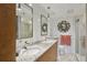 Bathroom featuring a double sink vanity with granite countertops, and a glass-enclosed shower at 1130 Piedmont Ne Ave # 709, Atlanta, GA 30309