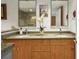 Well-lit bathroom with a double sink vanity, granite countertop, and decorative mirrors adds a touch of elegance at 1130 Piedmont Ne Ave # 709, Atlanta, GA 30309