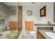 Bathroom features a modern glass shower with bench, decorative mirror, and updated vanity with granite countertop at 1130 Piedmont Ne Ave # 709, Atlanta, GA 30309