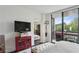 Relaxing bedroom features a stylish writing desk and balcony access with outdoor seating at 1130 Piedmont Ne Ave # 709, Atlanta, GA 30309