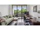 Comfortable living room area complete with office furniture and a view of a private outdoor balcony at 1130 Piedmont Ne Ave # 709, Atlanta, GA 30309