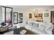 Bright living room featuring a comfortable white sectional sofa and access to a private balcony at 1130 Piedmont Ne Ave # 709, Atlanta, GA 30309