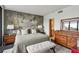Serene main bedroom showcases a queen bed with a unique mural wall, and wood furniture at 1130 Piedmont Ne Ave # 709, Atlanta, GA 30309