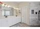 Luxurious bathroom featuring double sinks, marble tile shower, and contemporary fixtures at 1221 Fountain Head Ct, Lawrenceville, GA 30043