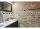 Stylish half-bathroom with decorative wall, dark wood vanity, and updated fixtures at 1221 Fountain Head Ct, Lawrenceville, GA 30043