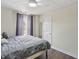 Comfortable bedroom with hardwood floors, ceiling fan, and a neutral color scheme for a relaxing atmosphere at 1221 Fountain Head Ct, Lawrenceville, GA 30043