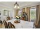 Inviting dining room with hardwood floors, decorative chandelier, and natural light from the windows at 1221 Fountain Head Ct, Lawrenceville, GA 30043
