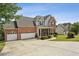 Charming two-story home with a brick facade, two-car garage, and well-manicured lawn at 1221 Fountain Head Ct, Lawrenceville, GA 30043