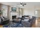 Comfortable living room with fireplace, ceiling fan, and large sectional sofa at 1221 Fountain Head Ct, Lawrenceville, GA 30043