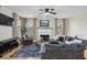 Large living room with fireplace, piano, and oversized chair and ottoman at 1221 Fountain Head Ct, Lawrenceville, GA 30043