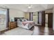 Spacious main bedroom features a tray ceiling, hardwood floors, and large windows for ample natural light at 1221 Fountain Head Ct, Lawrenceville, GA 30043