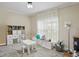 Bright playroom featuring a large window, patterned rug, and storage solutions for toys and books at 1221 Fountain Head Ct, Lawrenceville, GA 30043
