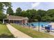 Community pool with ample seating and lush landscaping at 1221 Fountain Head Ct, Lawrenceville, GA 30043