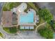Aerial view of community pool with lap lanes, kiddie splash area, clubhouse, and parking lot surrounded by greenery at 1820 Hunters Moon Dr, Alpharetta, GA 30005