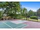 A fenced basketball court with a view of the pond, showing a pleasant recreational amenity for residents at 1820 Hunters Moon Dr, Alpharetta, GA 30005