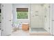 Light-filled bathroom with a walk-in shower and a woven hamper near a bright window at 1820 Hunters Moon Dr, Alpharetta, GA 30005